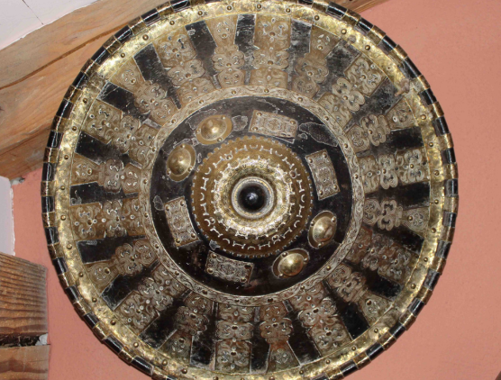 afar shield Conical shield with flared base and rimmed in the edges imitating a pointed hat The shield is made from thick leather possibly hippo skin and the outer surface of the shield is decorated with brass platings in the design of stylized patterns of plants and flowers The shield is that of the gafa gassa a parade shield offered as a gift to Ethiopian dignitaries and warlords Late 19th Century